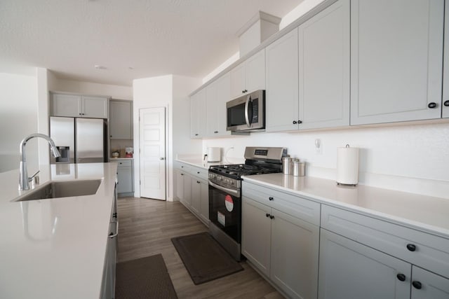 5769 W Austin Way, Fresno, CA 93722 - kitchen featuring appliances with stainless steel finishes, dark wood-style flooring, light countertops, and gray cabinets