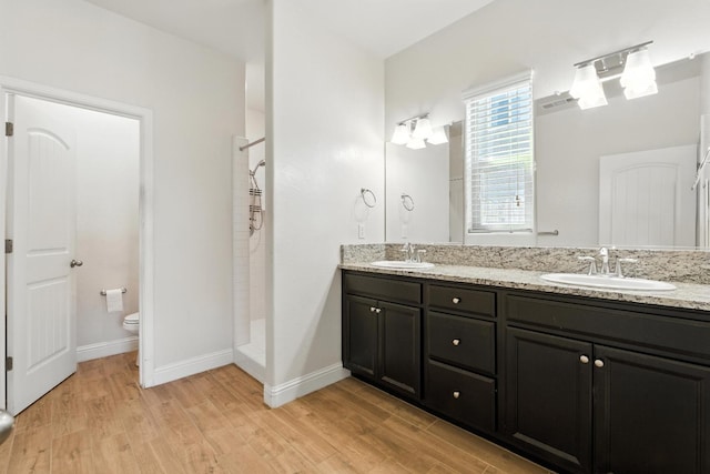 2456 Junipero Ave, Clovis, CA 93619 - bathroom with wood finished floors, double vanity, and a shower