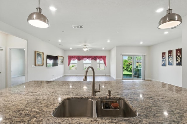 2456 Junipero Ave, Clovis, CA 93619 - kitchen with open floor plan, ceiling fan, healthy amount of natural light, stone countertops, and recessed lighting