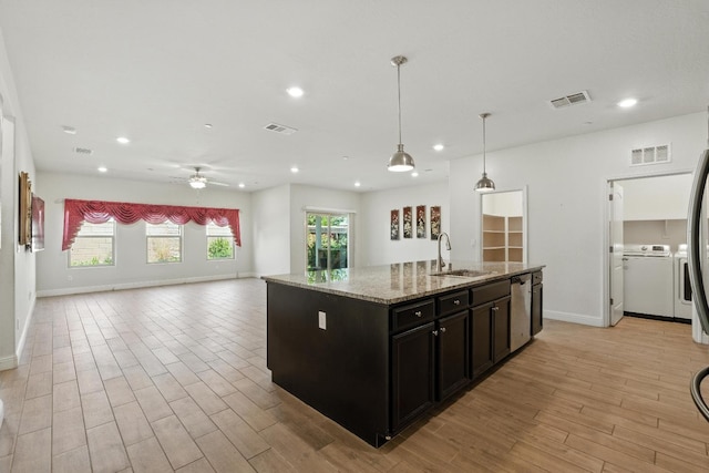 2456 Junipero Ave, Clovis, CA 93619 - kitchen with independent washer and dryer, recessed lighting, open floor plan, light wood-type flooring, and a kitchen island with sink