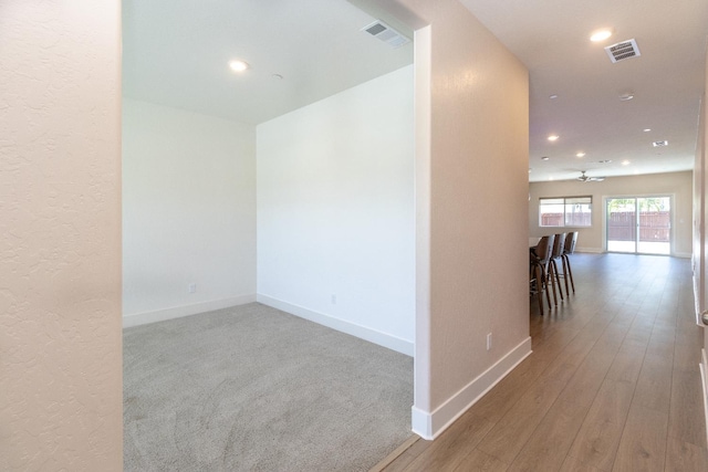 153 N Bliss Ave, Fresno, CA 93727 - hallway with recessed lighting, a textured wall, and wood finished floors
