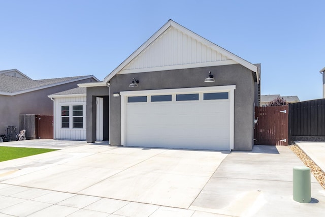 153 N Bliss Ave, Fresno, CA 93727 - single story home featuring a garage, concrete driveway, stucco siding, and board and batten siding