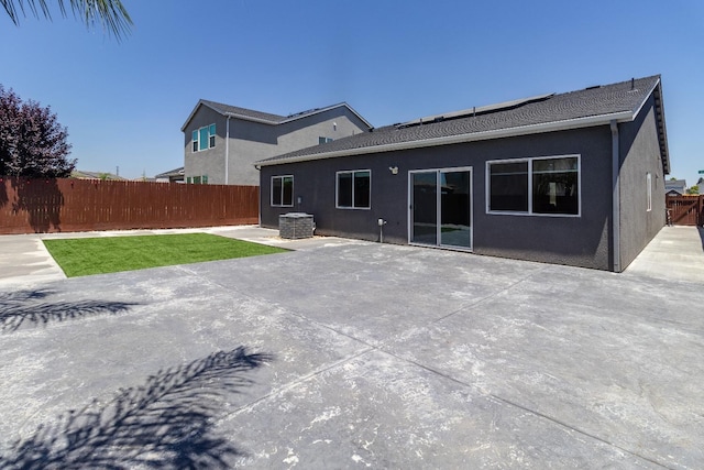 153 N Bliss Ave, Fresno, CA 93727 - back of property featuring a fenced backyard, stucco siding, and a patio