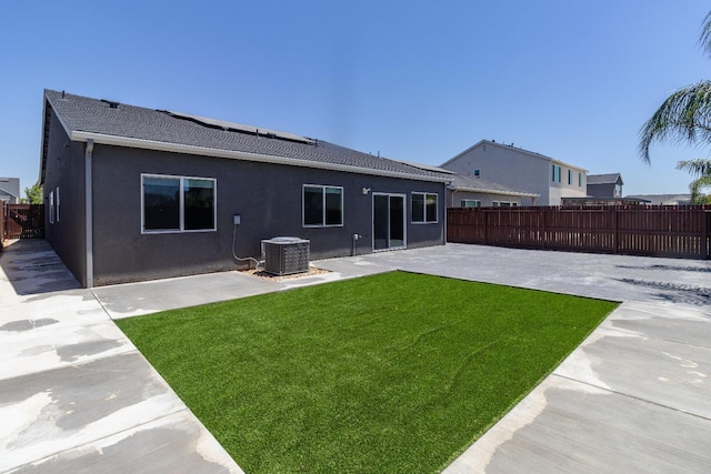153 N Bliss Ave, Fresno, CA 93727 - rear view of property featuring a patio, a fenced backyard, stucco siding, and roof mounted solar panels