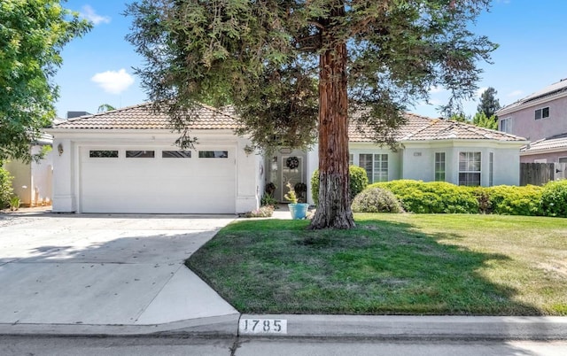 1785 E Portland Ave, Fresno, CA 93720 - view of front of property with a tile roof, an attached garage, stucco siding, and a front yard