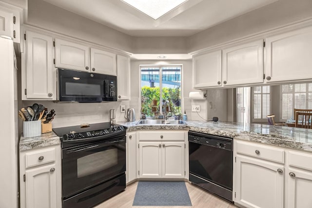 1785 E Portland Ave, Fresno, CA 93720 - kitchen with black appliances, white cabinets, and plenty of natural light