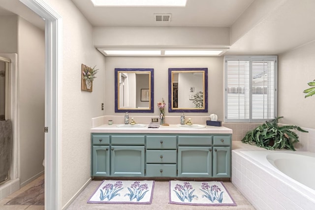 1785 E Portland Ave, Fresno, CA 93720 - bathroom featuring double vanity, a bath, and a shower with shower door