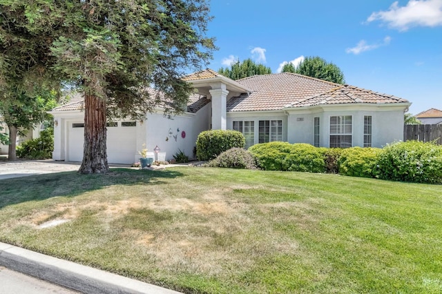 1785 E Portland Ave, Fresno, CA 93720 - mediterranean / spanish house featuring stucco siding, a tile roof, a garage, and concrete driveway
