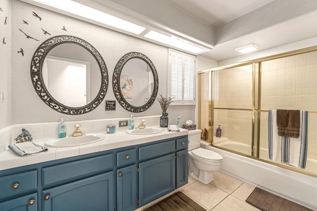 1785 E Portland Ave, Fresno, CA 93720 - bathroom with double vanity, shower / bath combination with glass door, and tile patterned flooring