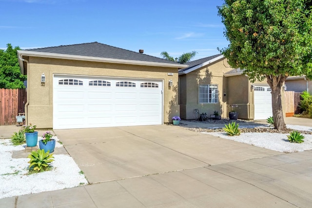 205 N Douglas Ave, Fresno, CA 93727 - ranch-style home featuring concrete driveway, an attached garage, and stucco siding