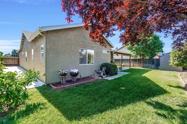 205 N Douglas Ave, Fresno, CA 93727 - back of property featuring stucco siding, a fenced backyard, a storage shed, and a patio area