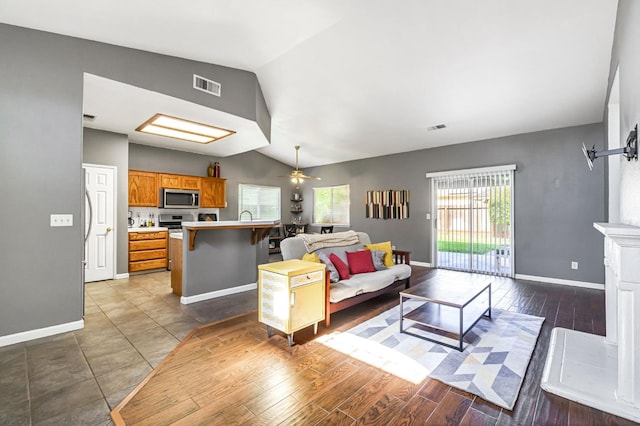 205 N Douglas Ave, Fresno, CA 93727 - living area featuring vaulted ceiling, a ceiling fan, and wood finished floors