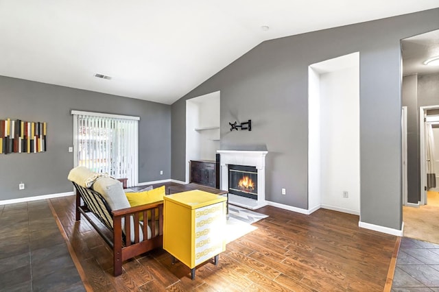 205 N Douglas Ave, Fresno, CA 93727 - living area featuring vaulted ceiling, a glass covered fireplace, and wood finished floors