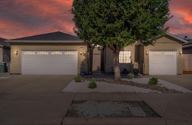 205 N Douglas Ave, Fresno, CA 93727 - ranch-style home featuring concrete driveway, a garage, and stucco siding