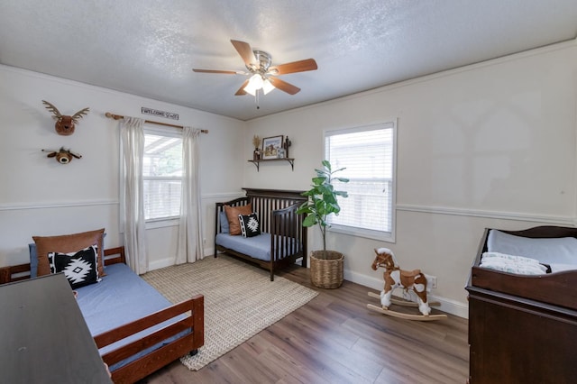 3054 E Brown Ave, Fresno, CA 93703 - bedroom with wood finished floors, a ceiling fan, and a textured ceiling