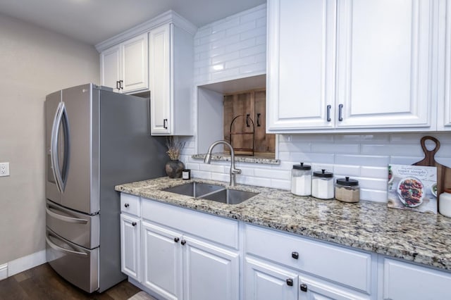 3054 E Brown Ave, Fresno, CA 93703 - kitchen with decorative backsplash, white cabinetry, freestanding refrigerator, and light stone counters