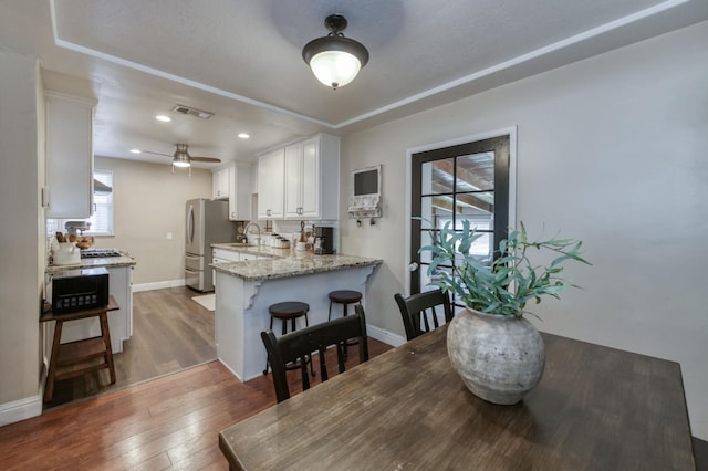 3054 E Brown Ave, Fresno, CA 93703 - dining space with wood finished floors, a ceiling fan, recessed lighting, and a tray ceiling