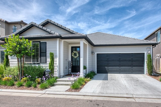 1363 E Via Prato Dr, Fresno, CA 93730 - view of front of property with driveway, a garage, and a tile roof