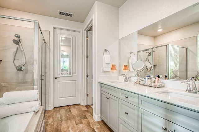 1363 E Via Prato Dr, Fresno, CA 93730 - bathroom featuring a shower stall, double vanity, wood finished floors, and plenty of natural light
