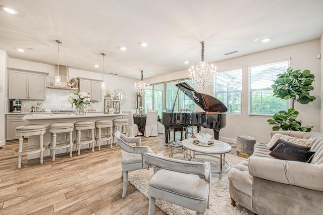 1363 E Via Prato Dr, Fresno, CA 93730 - living room with a chandelier, light wood-style flooring, recessed lighting, and plenty of natural light