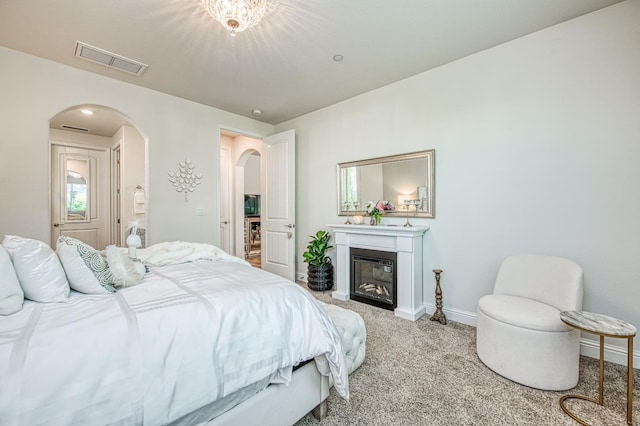 1363 E Via Prato Dr, Fresno, CA 93730 - carpeted bedroom with arched walkways and a glass covered fireplace