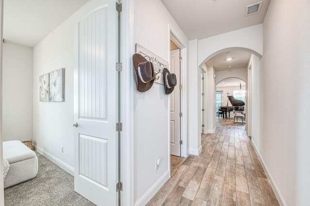 1363 E Via Prato Dr, Fresno, CA 93730 - hallway featuring arched walkways and light wood finished floors