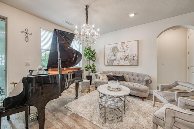 1363 E Via Prato Dr, Fresno, CA 93730 - living room featuring arched walkways, wood finished floors, and a chandelier