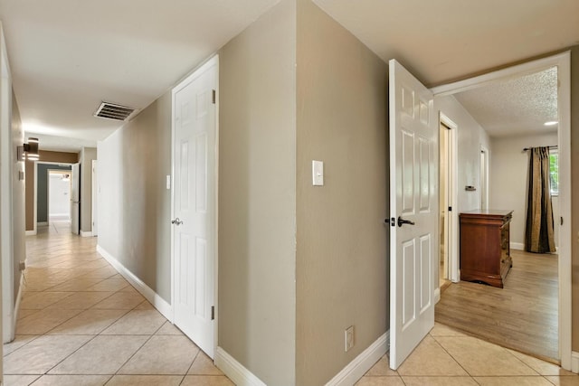 6052 N Spalding Ave, Fresno, CA 93710 - hall with light tile patterned floors and baseboards