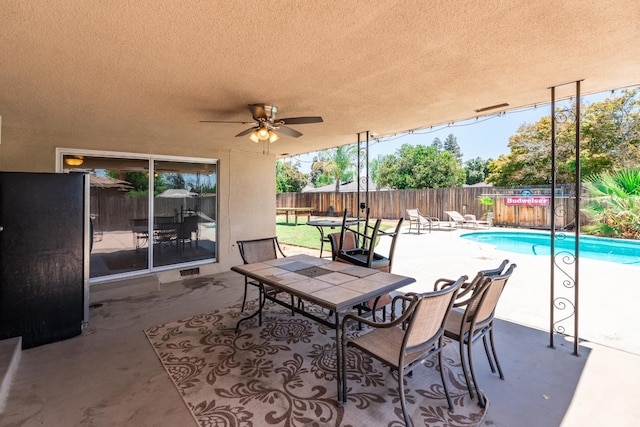 6052 N Spalding Ave, Fresno, CA 93710 - fenced backyard with a ceiling fan and a patio area