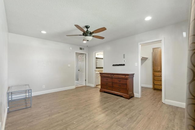 6052 N Spalding Ave, Fresno, CA 93710 - unfurnished living room with ceiling fan, light wood-type flooring, recessed lighting, and a textured ceiling