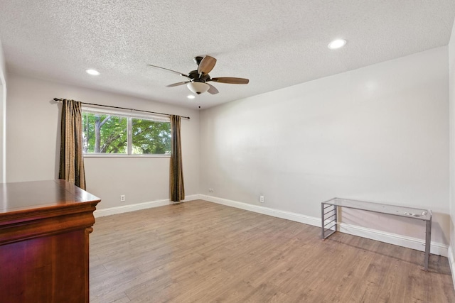 6052 N Spalding Ave, Fresno, CA 93710 - empty room featuring a ceiling fan, wood finished floors, a textured ceiling, and recessed lighting