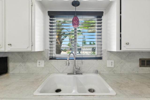 6052 N Spalding Ave, Fresno, CA 93710 - kitchen view of light countertops, white cabinets, backsplash, and pendant lighting