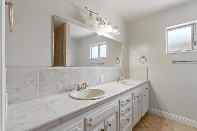 6052 N Spalding Ave, Fresno, CA 93710 - bathroom featuring double vanity, tile patterned flooring, and backsplash