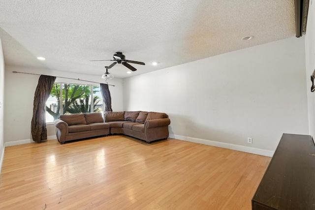 6052 N Spalding Ave, Fresno, CA 93710 - living area with ceiling fan, light wood-type flooring, a textured ceiling, and recessed lighting