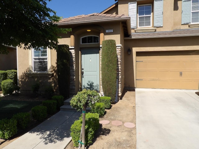 1982 N Todd Hedrick, Clovis, CA 93619 - view of front of property with stucco siding, an attached garage, driveway, and a tile roof