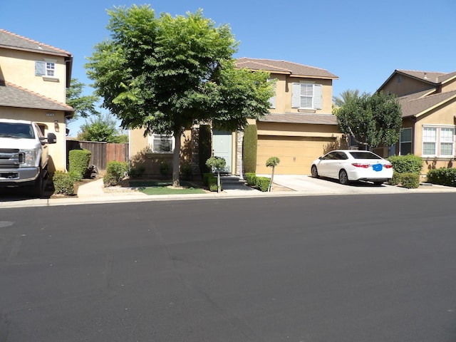 1982 N Todd Hedrick, Clovis, CA 93619 - obstructed view of property with driveway, stucco siding, and an attached garage