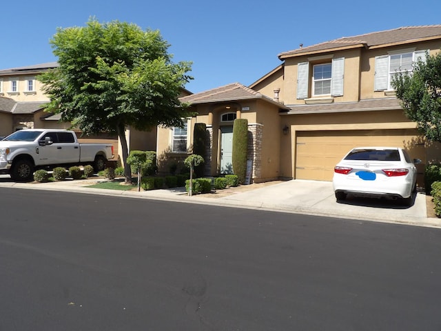 1982 N Todd Hedrick, Clovis, CA 93619 - view of front of house with stucco siding, driveway, and a garage