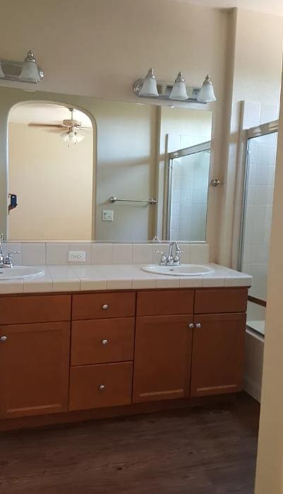 1982 N Todd Hedrick, Clovis, CA 93619 - bathroom with double vanity, wood finished floors, ceiling fan, and bath / shower combo with glass door