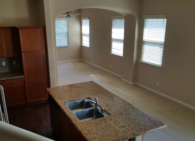 1982 N Todd Hedrick, Clovis, CA 93619 - kitchen featuring ceiling fan, arched walkways, light colored carpet, and light stone counters