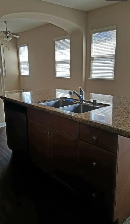 1982 N Todd Hedrick, Clovis, CA 93619 - kitchen featuring arched walkways, light stone countertops, and a ceiling fan