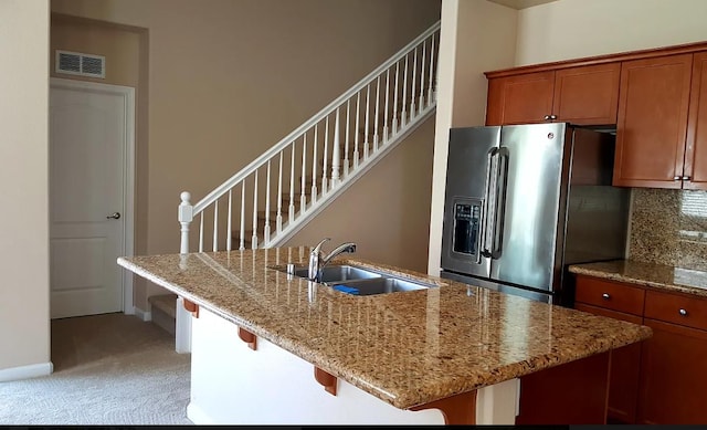1982 N Todd Hedrick, Clovis, CA 93619 - kitchen featuring stainless steel refrigerator with ice dispenser, brown cabinets, light carpet, and decorative backsplash