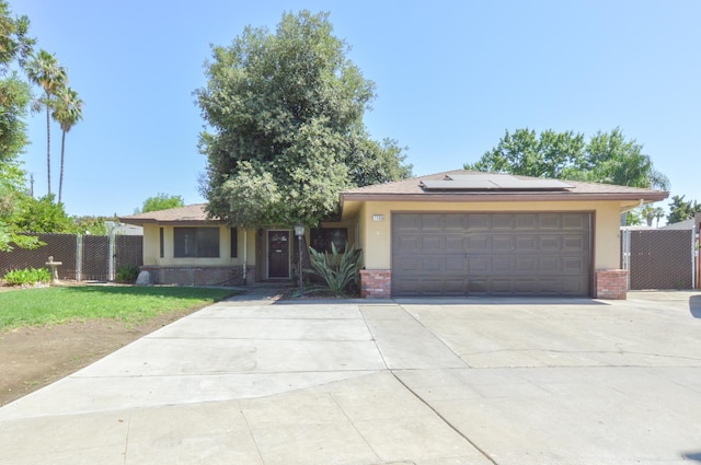 1325 Griffith Ave, Clovis, CA 93612 - view of front of house with solar panels, brick siding, and stucco siding