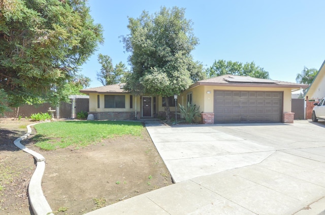 1325 Griffith Ave, Clovis, CA 93612 - single story home with roof mounted solar panels, stucco siding, an attached garage, brick siding, and driveway