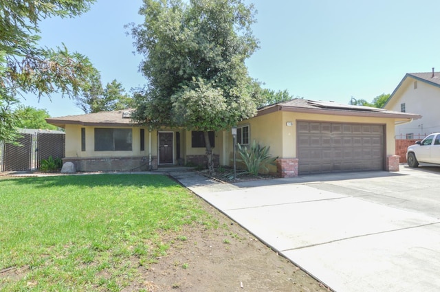 1325 Griffith Ave, Clovis, CA 93612 - ranch-style house featuring stucco siding, an attached garage, solar panels, driveway, and brick siding