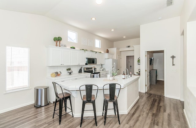 5783 N State St, Fresno, CA 93722 - kitchen with appliances with stainless steel finishes, light countertops, a kitchen breakfast bar, light wood-style floors, and lofted ceiling