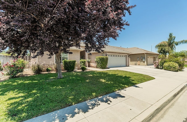 5783 N State St, Fresno, CA 93722 - view of property hidden behind natural elements featuring stucco siding, a garage, and concrete driveway
