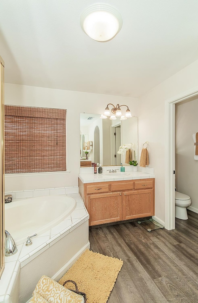 5783 N State St, Fresno, CA 93722 - bathroom with vanity, a bath, and wood finished floors