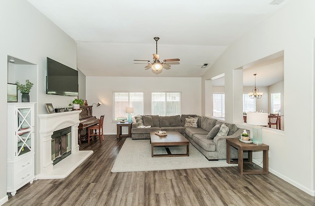 5783 N State St, Fresno, CA 93722 - living room with vaulted ceiling, a ceiling fan, wood finished floors, a chandelier, and a fireplace with raised hearth
