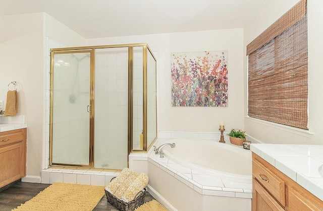 5783 N State St, Fresno, CA 93722 - bathroom featuring a stall shower, vanity, a bath, and wood finished floors