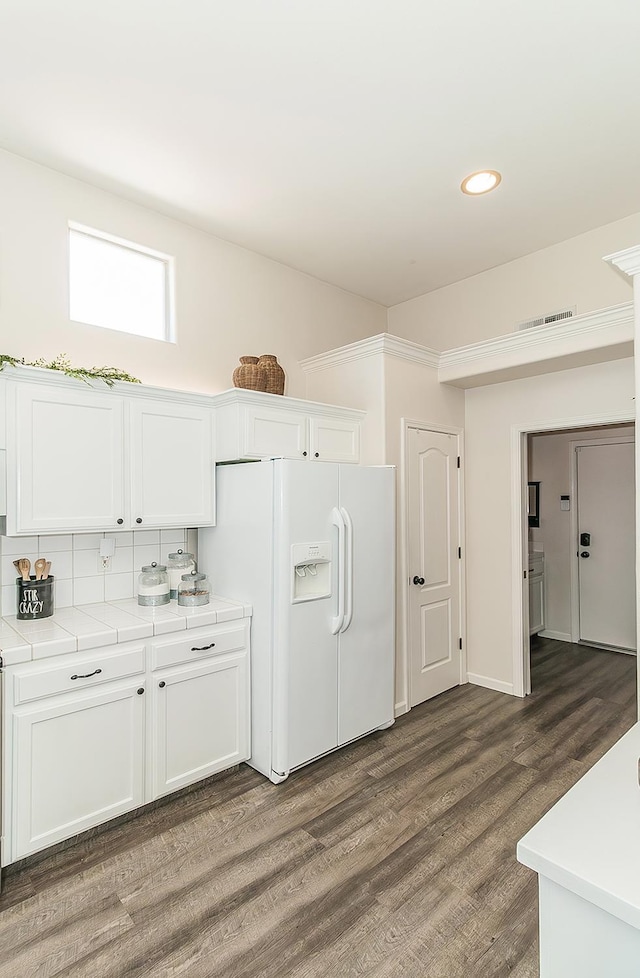 5783 N State St, Fresno, CA 93722 - kitchen featuring white fridge with ice dispenser, white cabinetry, dark wood finished floors, tile counters, and recessed lighting